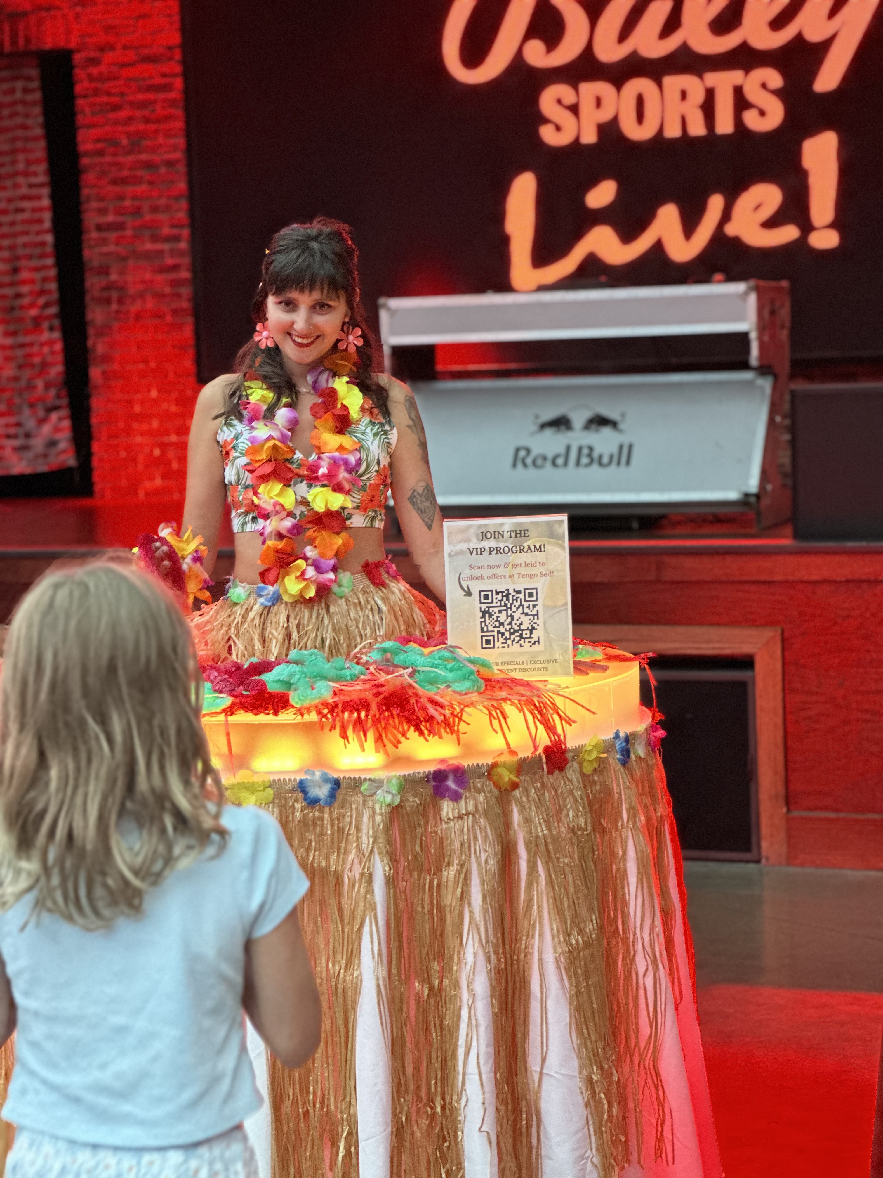 Luau themed grass skirt strolling table for giveaways