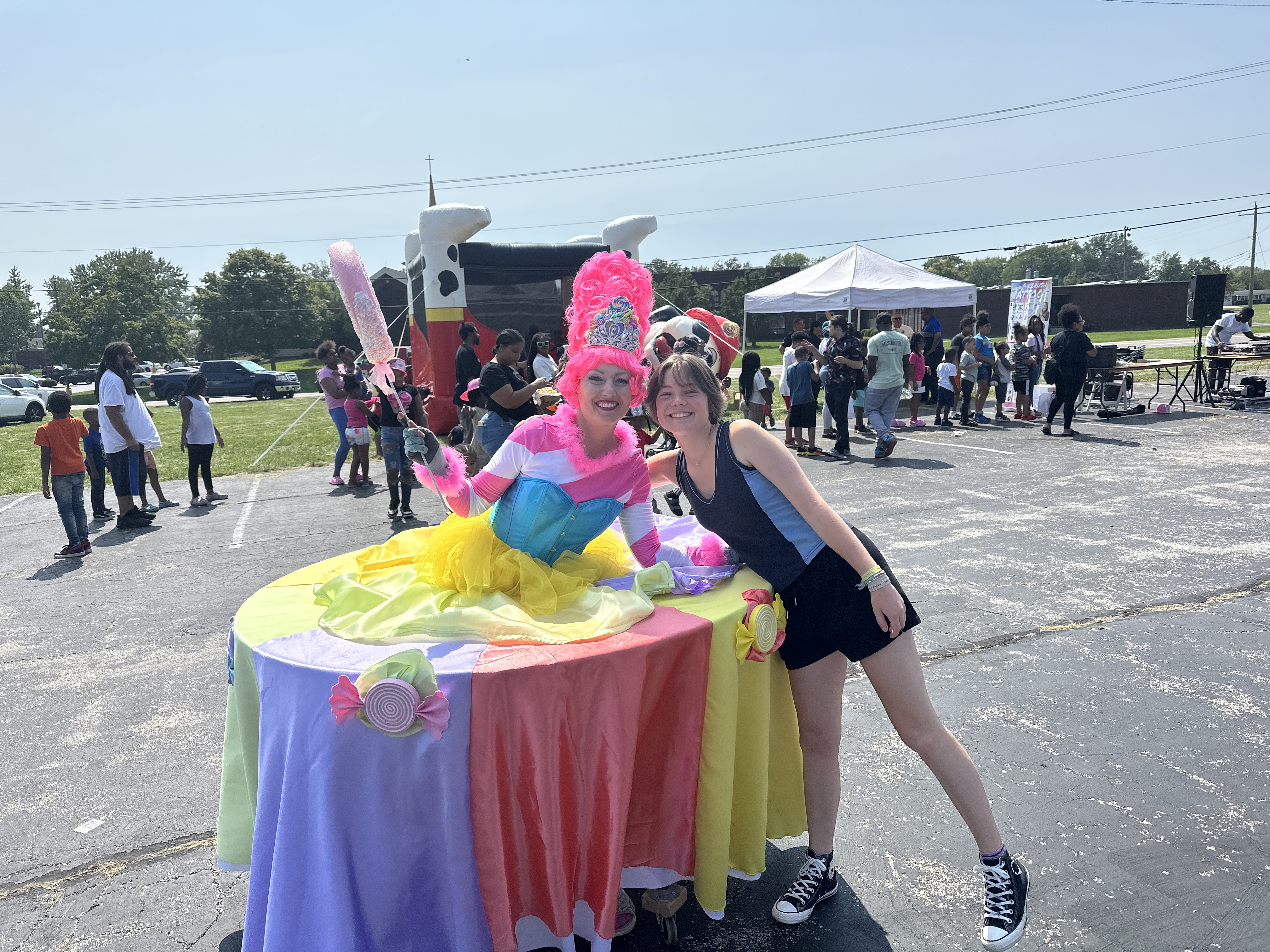 Young lady gets a picture with the candyland strolling table