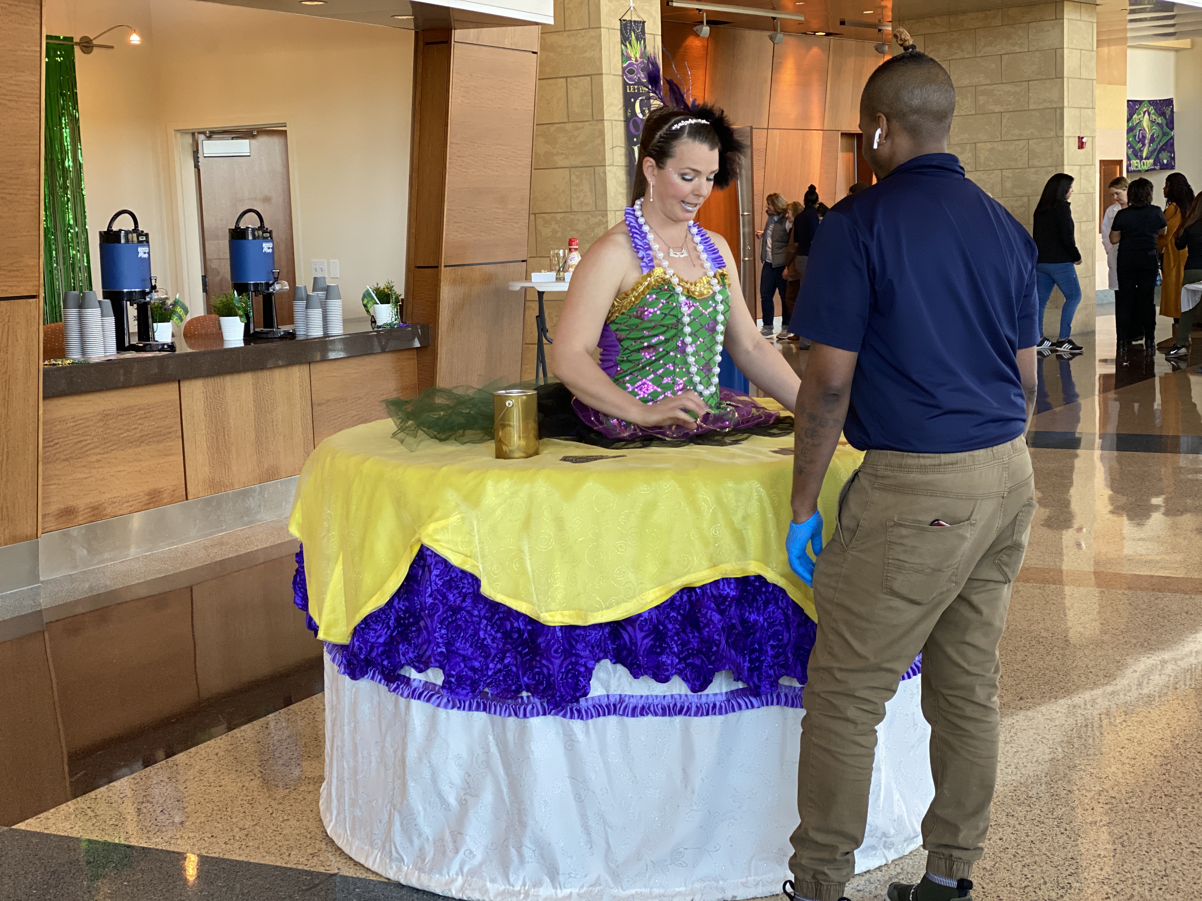 Mardi gras themed strolling table engaging patrons