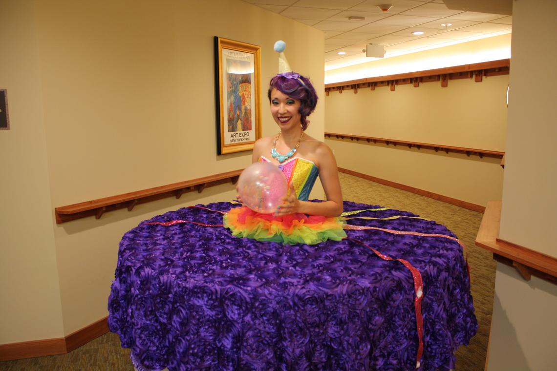 Circus Kaput's celebration cake strolling table in purple and white.